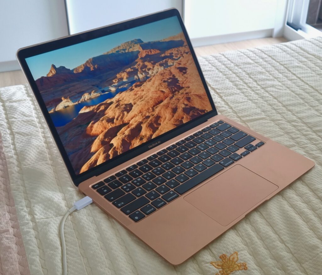 macbookair gold on bed